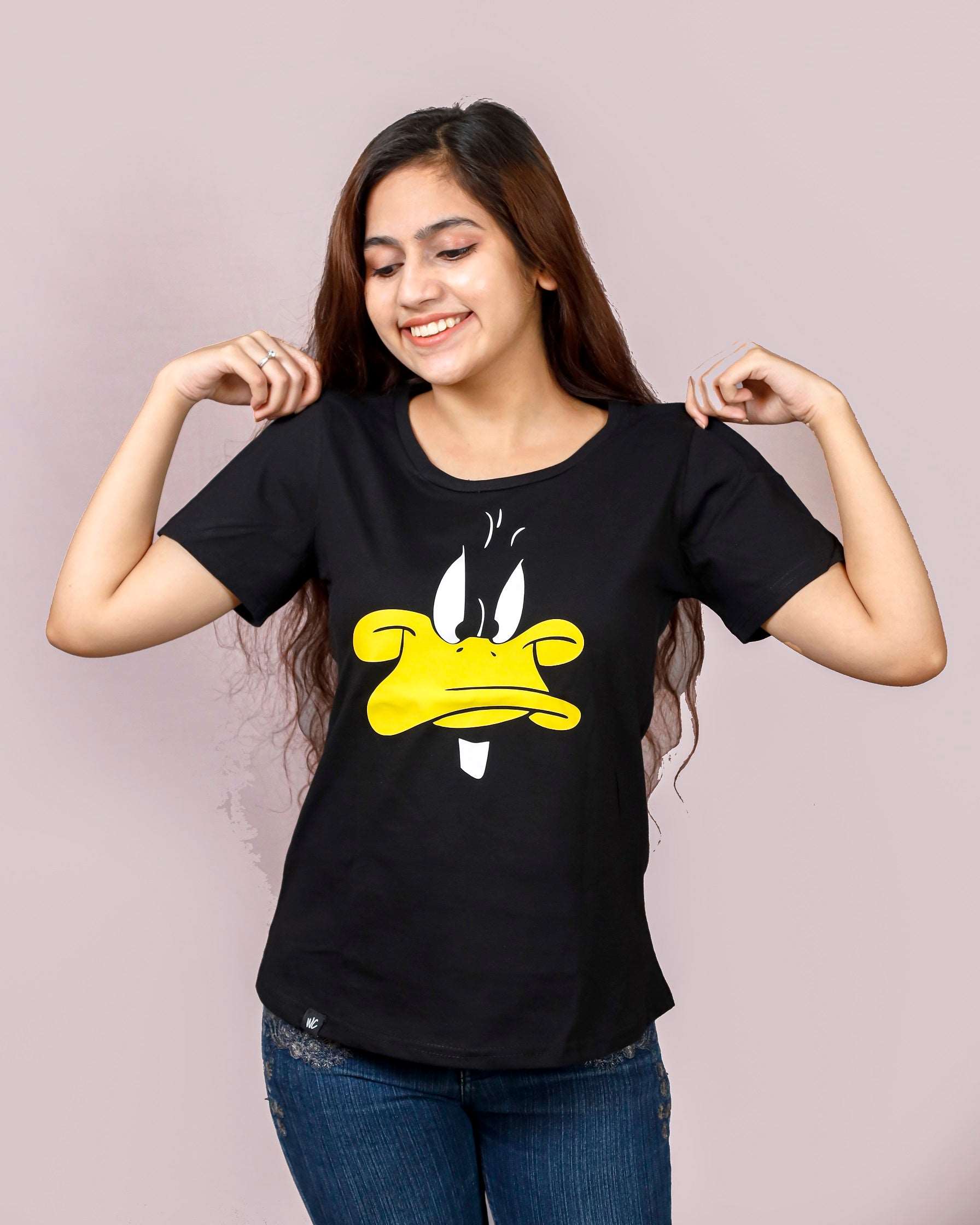 women standing and wearing a black daffy duck printed womens tshirt